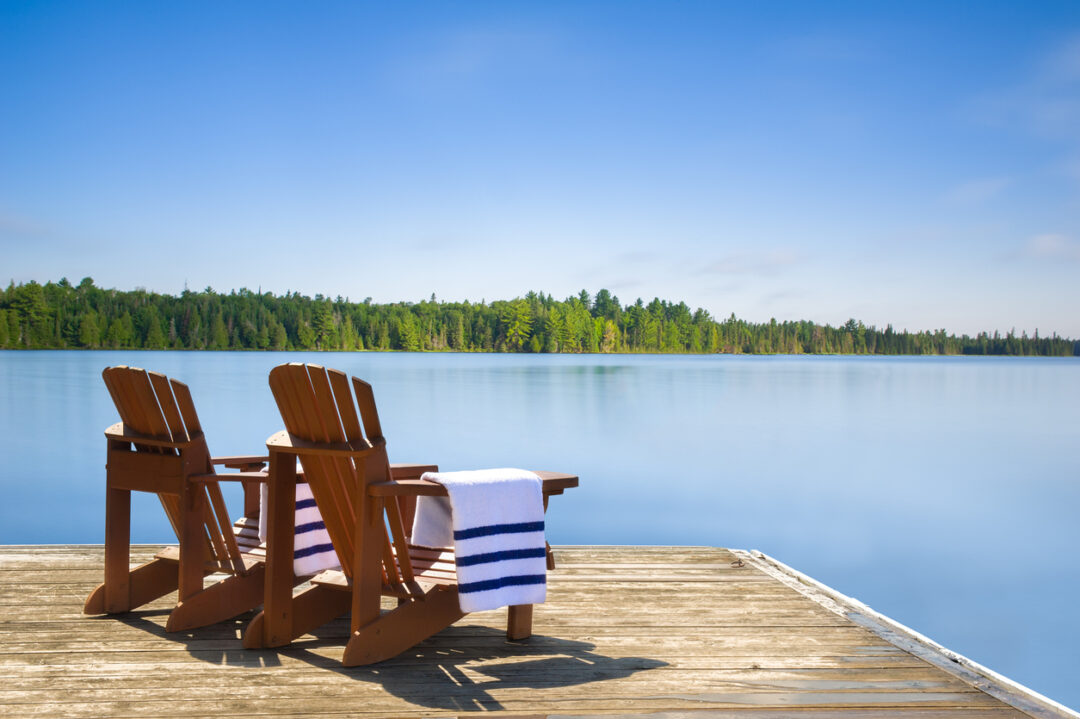 Chairs with folded towels on a dock, long exposure shot.